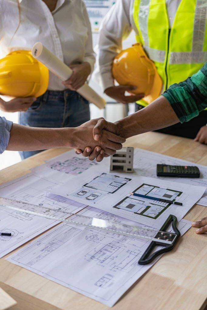 Meeting engineers or architects for projects, working with partners and engineering tools to create workplace models and blueprints. construction concept